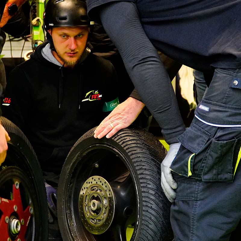 Kingtyre K01 racing motorcycle tire on wet racetrack.