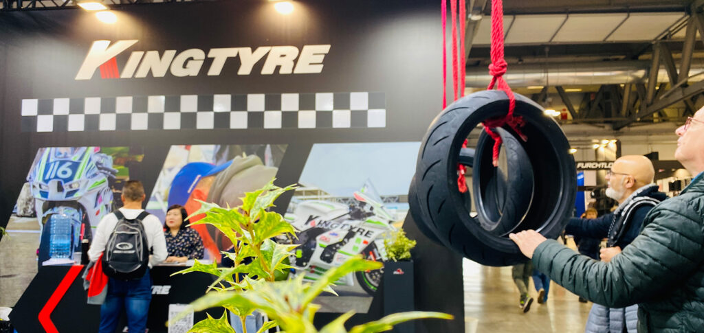 Crowds visiting the EICMA motorcycle show in Milan with Kingtyre booth in the background
